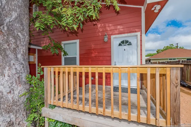 a view of a brick house with a small yard