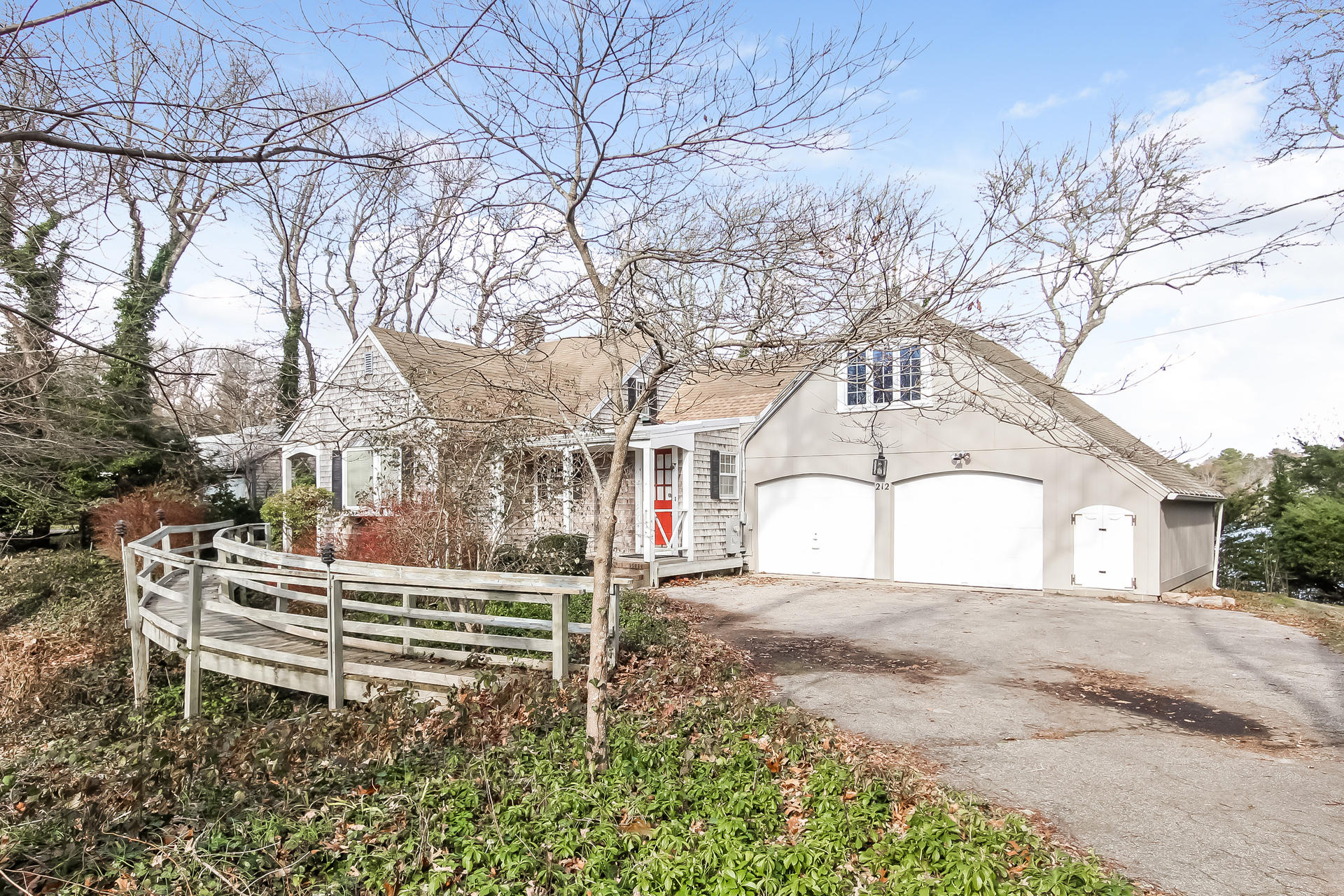 212 Holly Point Road Centerville, MA 02632 - Photo 1 of 30 a white house that has a tree in front of it