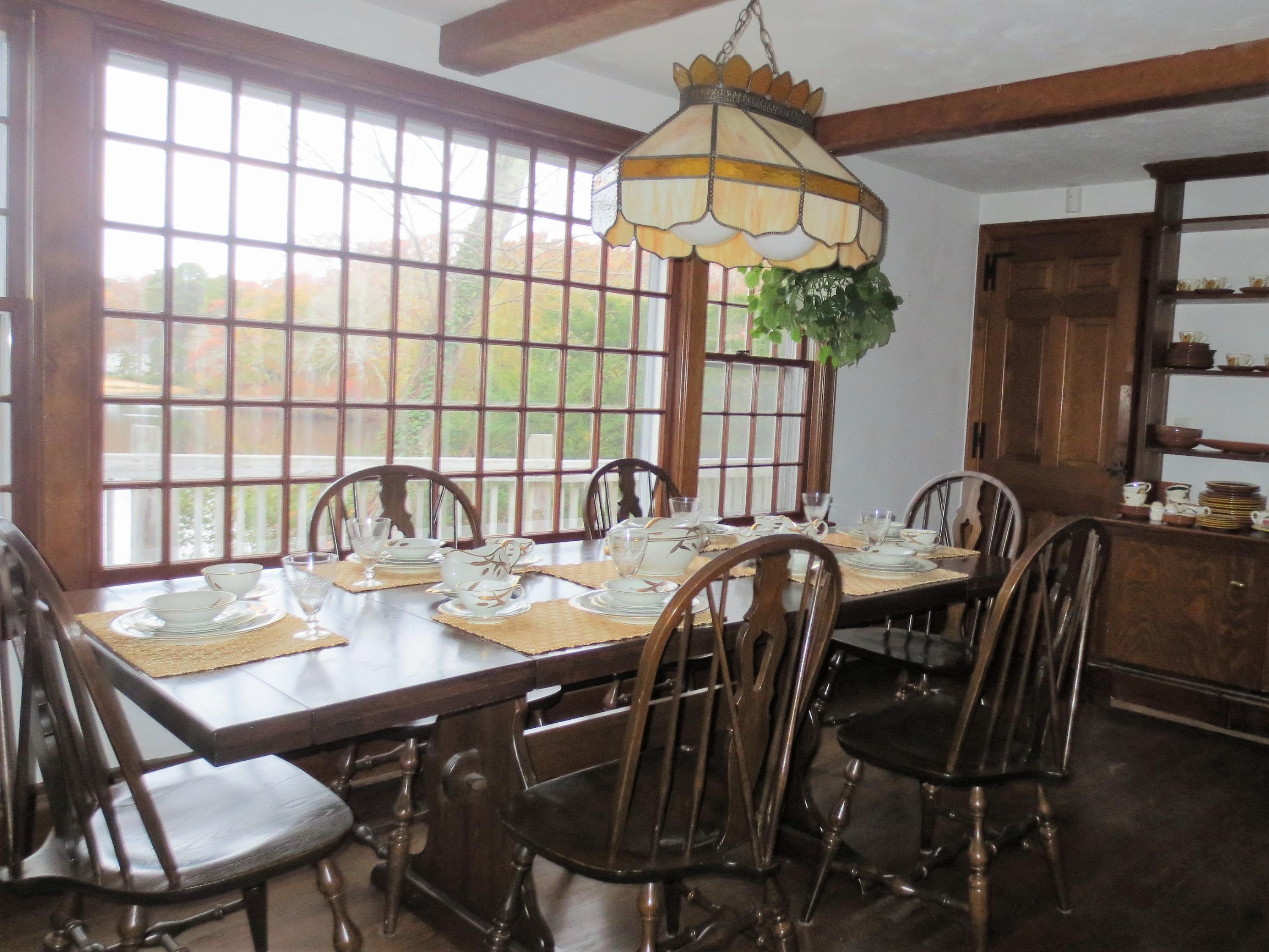 212 Holly Point Road Centerville, MA 02632 - Photo 17 of 30 a view of a dining room with furniture window and outside view