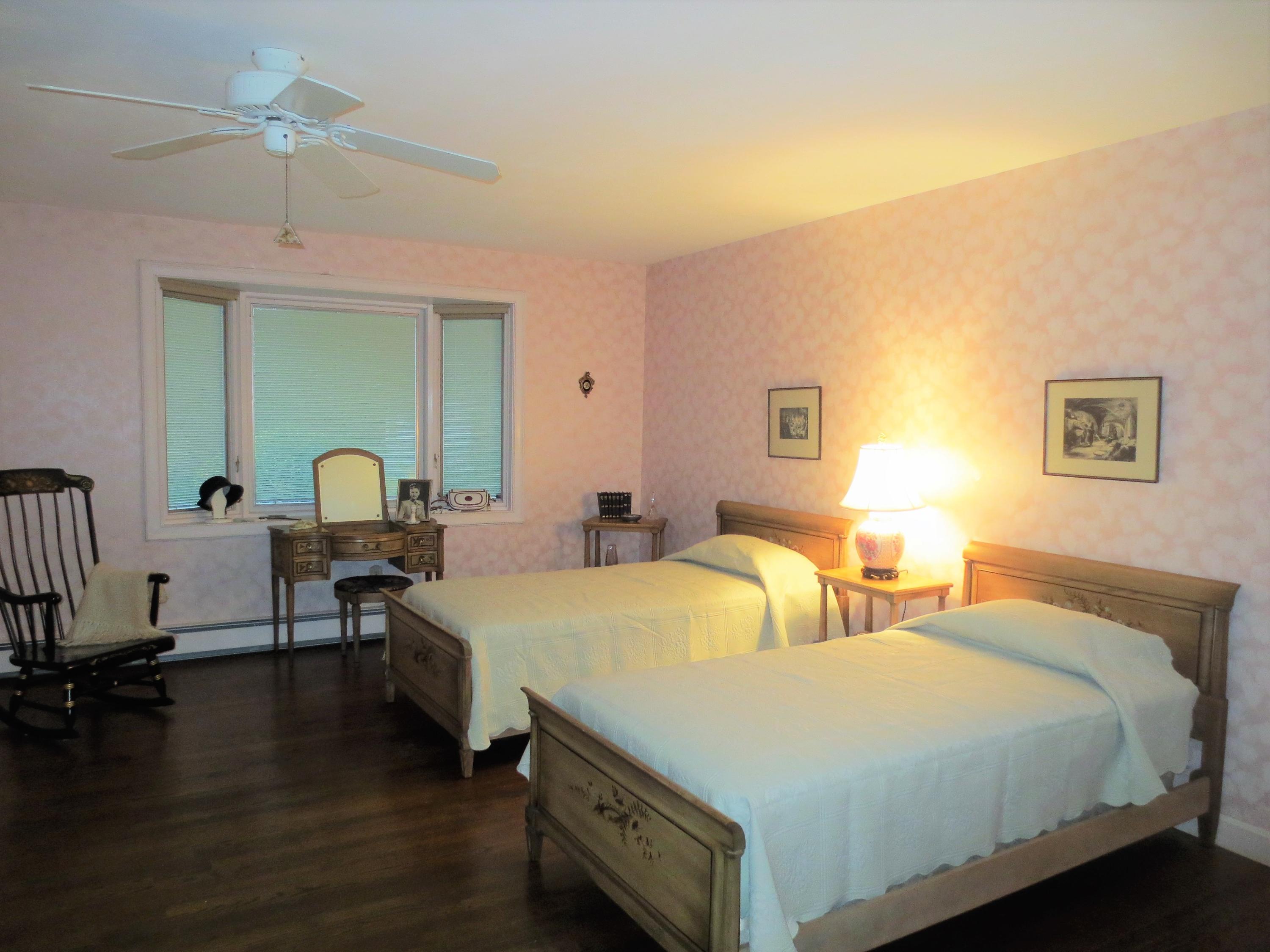 212 Holly Point Road Centerville, MA 02632 - Photo 20 of 30 a spacious bedroom with two beds and a table