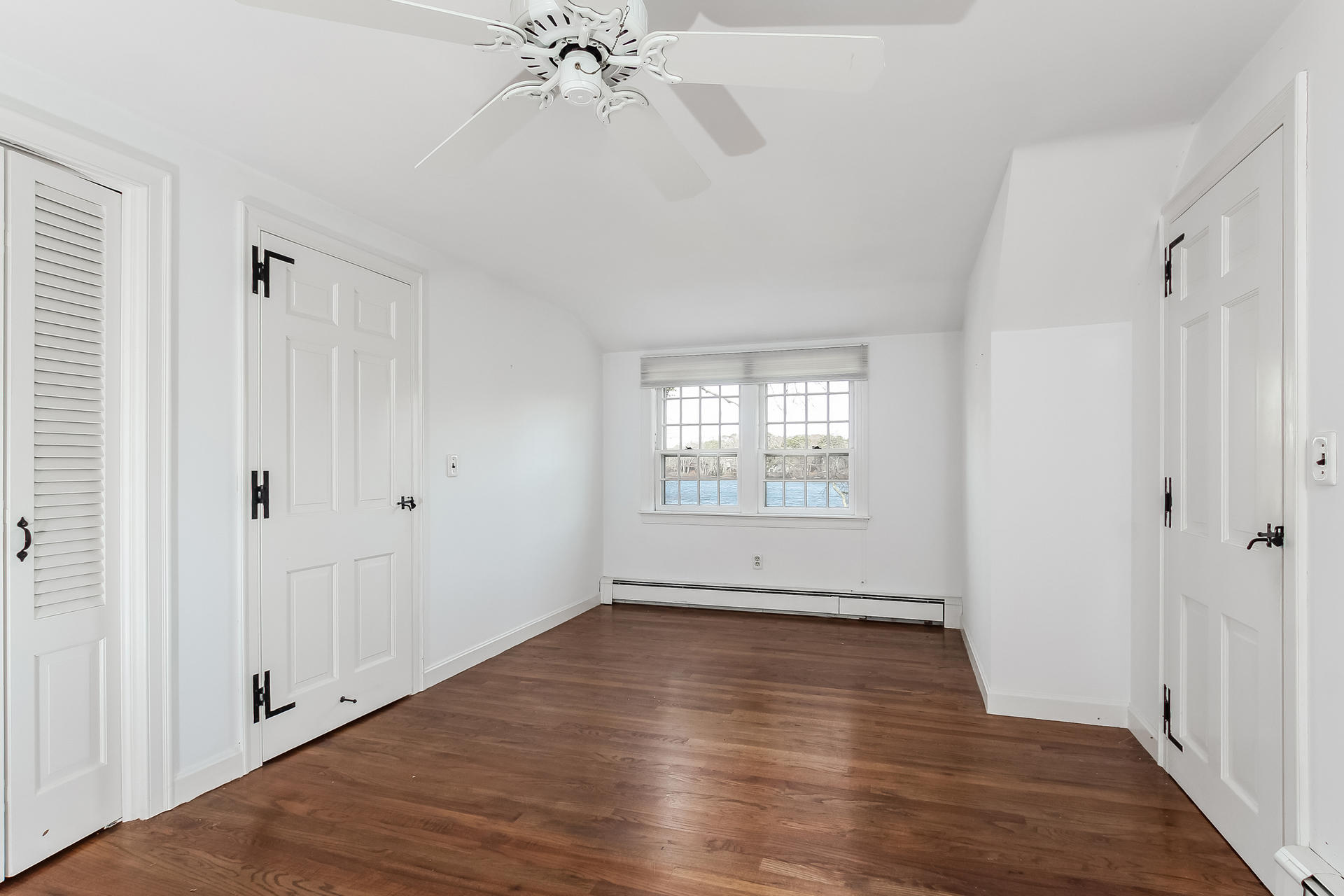 212 Holly Point Road Centerville, MA 02632 - Photo 25 of 30 a view of an empty room with wooden floor and a window