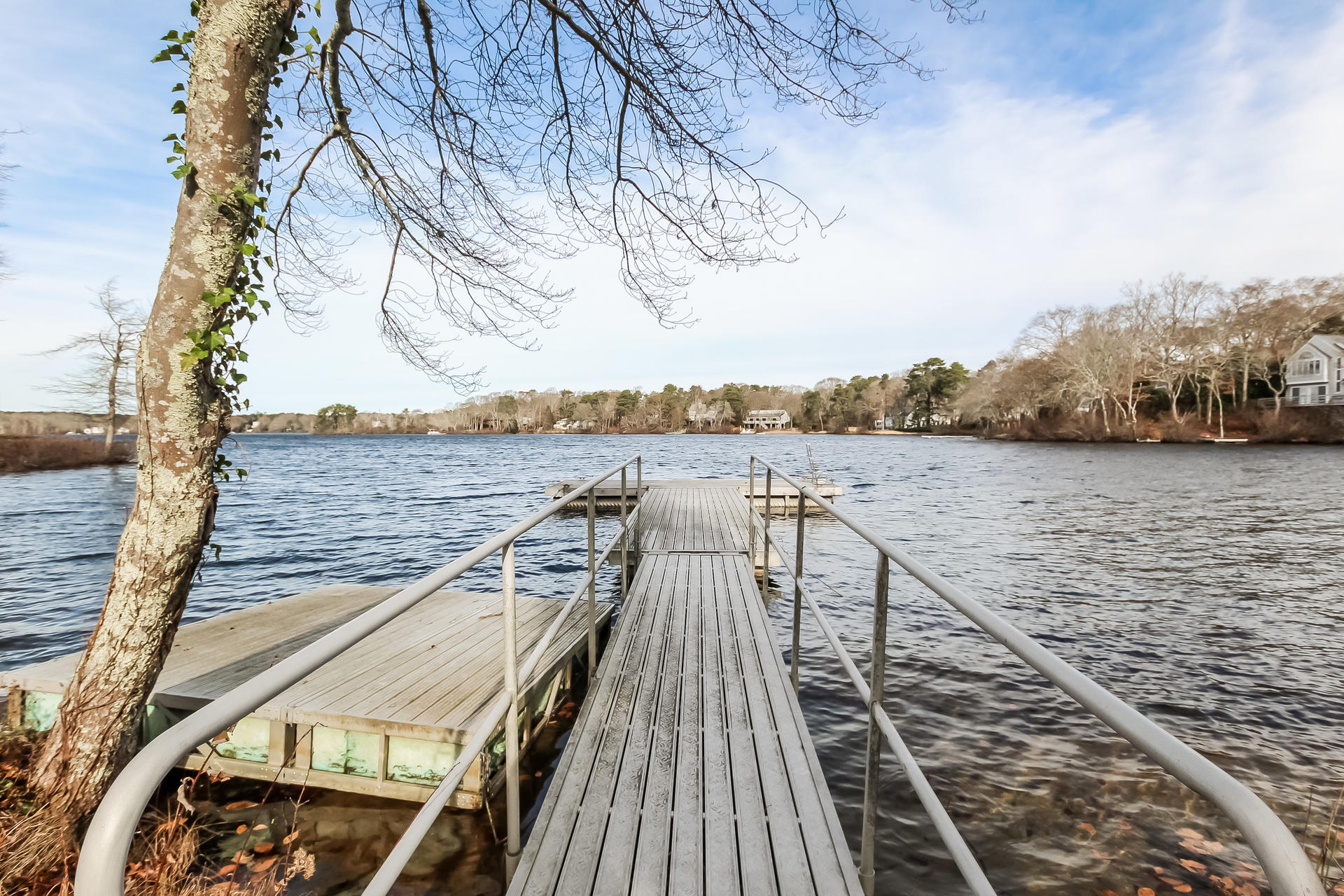 212 Holly Point Road Centerville, MA 02632 - Photo 3 of 30 a view of a terrace with wooden floor and lake view