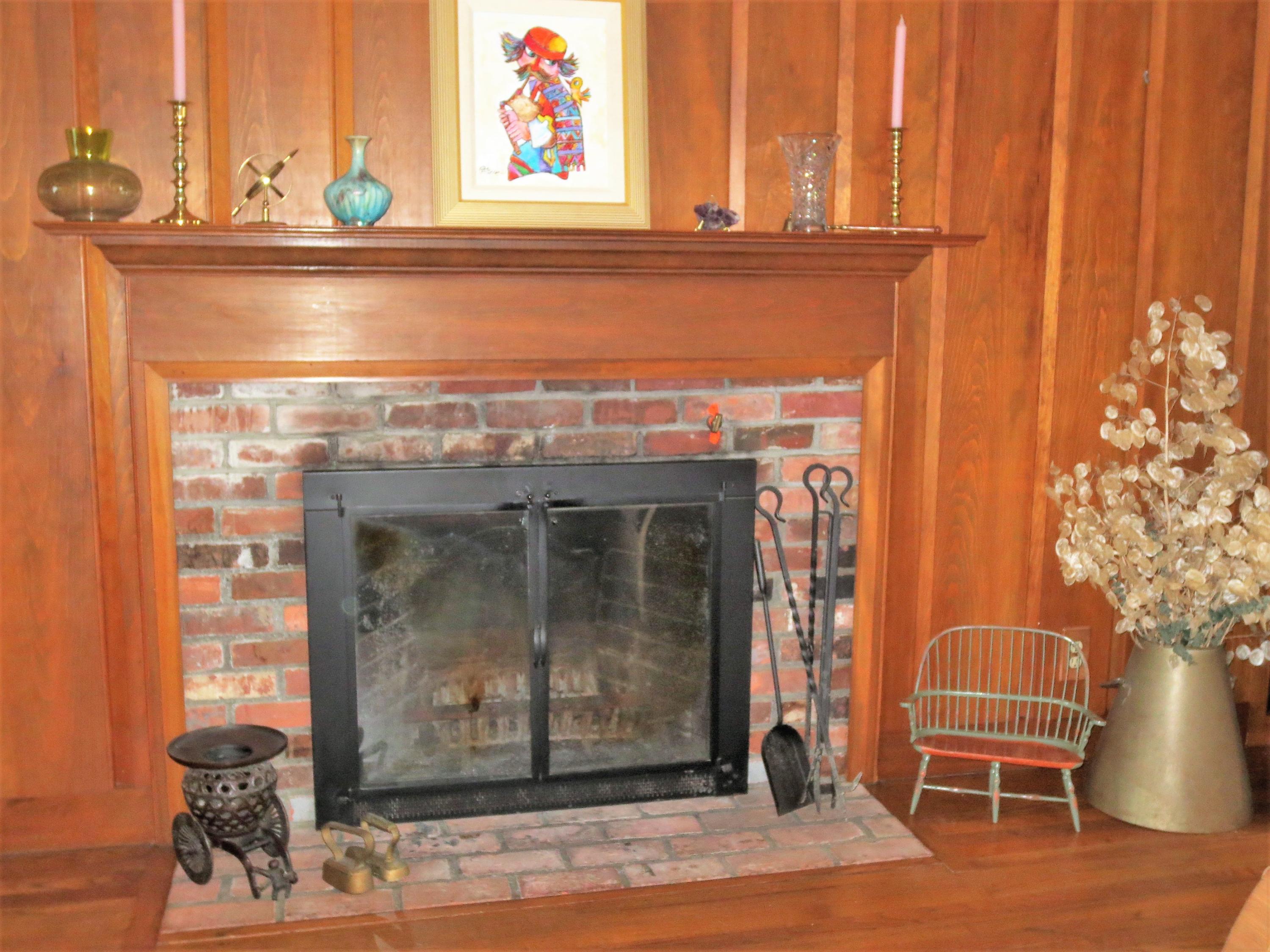 212 Holly Point Road Centerville, MA 02632 - Photo 8 of 30 a view of a fireplace with a potted plant and a table