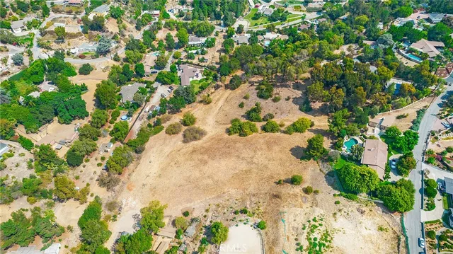 an aerial view of residential houses with yard