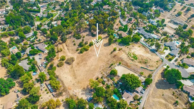 an aerial view of residential houses with yard