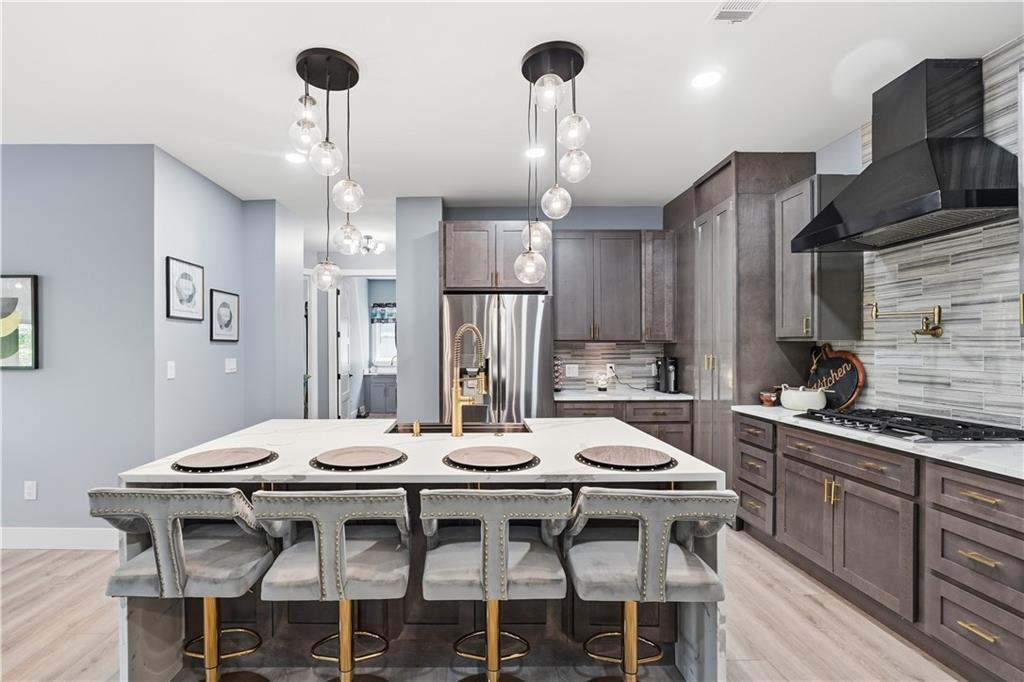 2021 Lakeview Parkway Villa Rica, GA 30180 - Photo 34 of 112 a kitchen with a dining table chairs stainless steel appliances and cabinets