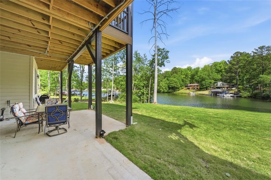 2021 Lakeview Parkway Villa Rica, GA 30180 - Photo 67 of 112 a view of a patio with a table and chairs under an umbrella