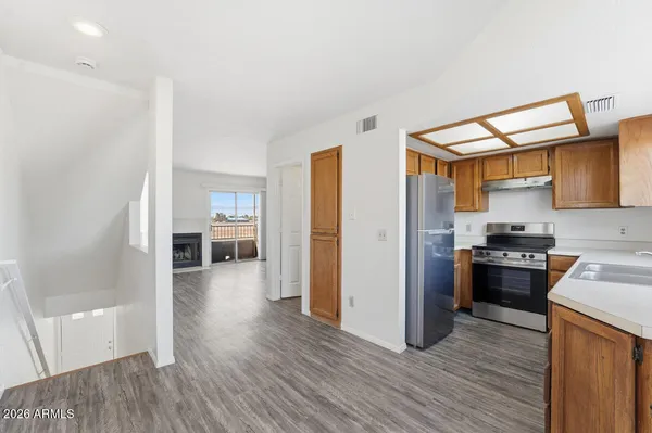 a kitchen with a refrigerator and a stove top oven