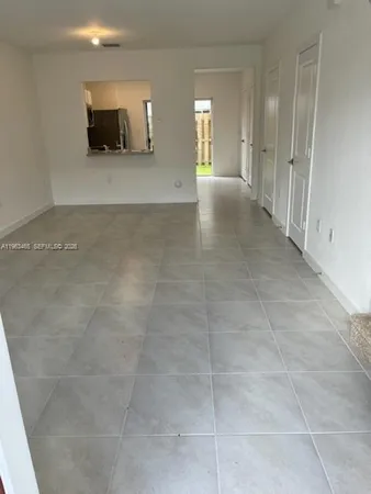 a view of a livingroom with wooden floor and a sink