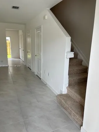 a view of a big room with staircase