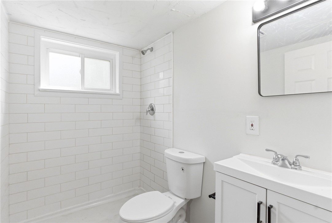 40 Woods Road Springboro, OH 45066 - Photo 50 of 57 Bright and clean bathroom features a spacious shower with subway tile, a sleek vanity, and modern fixtures.