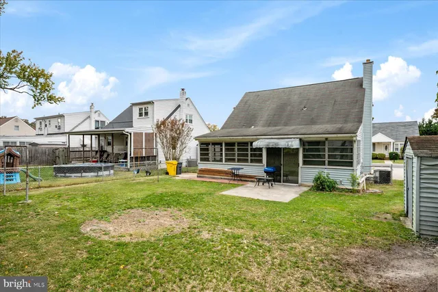 a backyard of a house with barbeque oven table and chairs