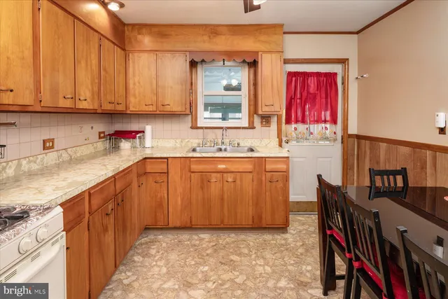 a kitchen with stainless steel appliances granite countertop a sink and cabinets