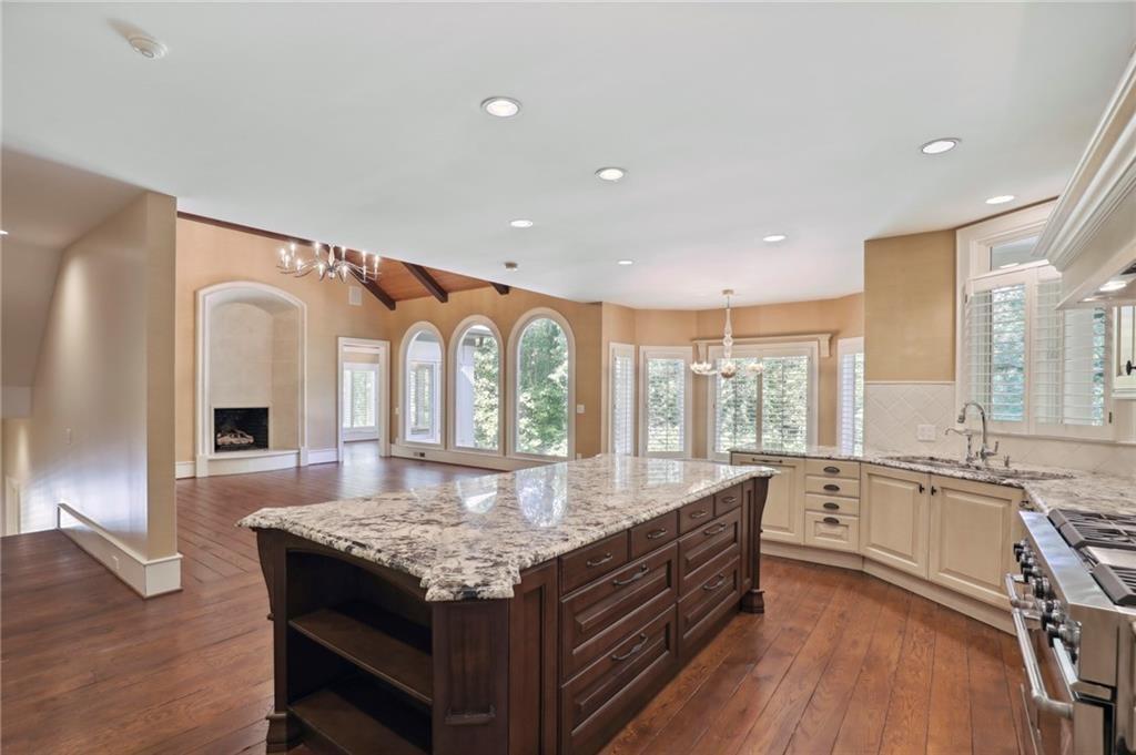 1965 West Wesley Road Northwest Atlanta, GA 30327 - Photo 20 of 34 a large kitchen with granite countertop a stove and a sink