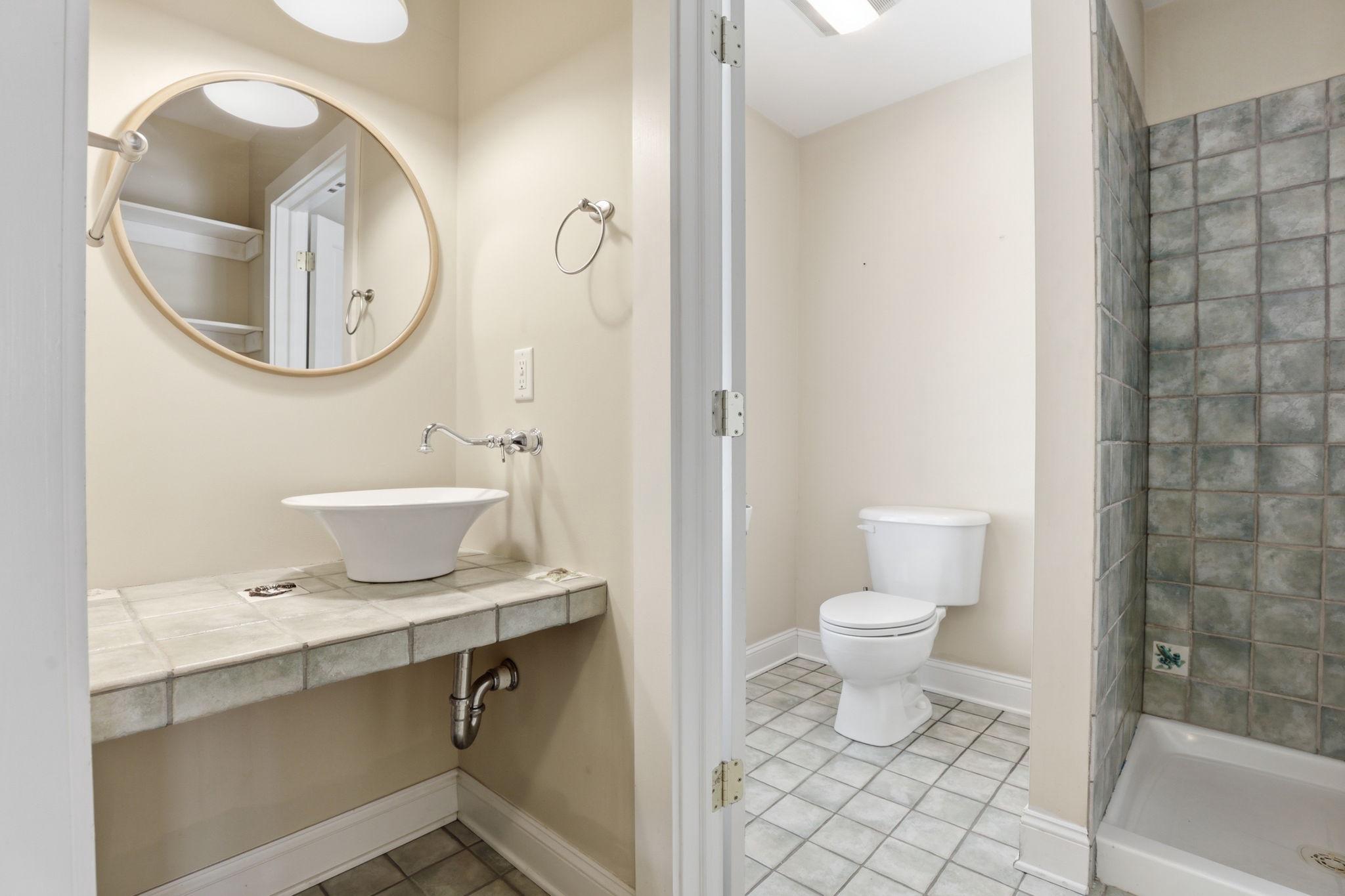 5865 Deale Beach Road Deale, MD 20751 - Photo 34 of 45 a bathroom with a sink a mirror a toilet and a shower