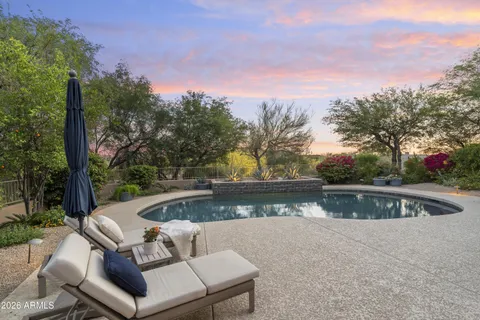 a view of a swimming pool with outdoor seating
