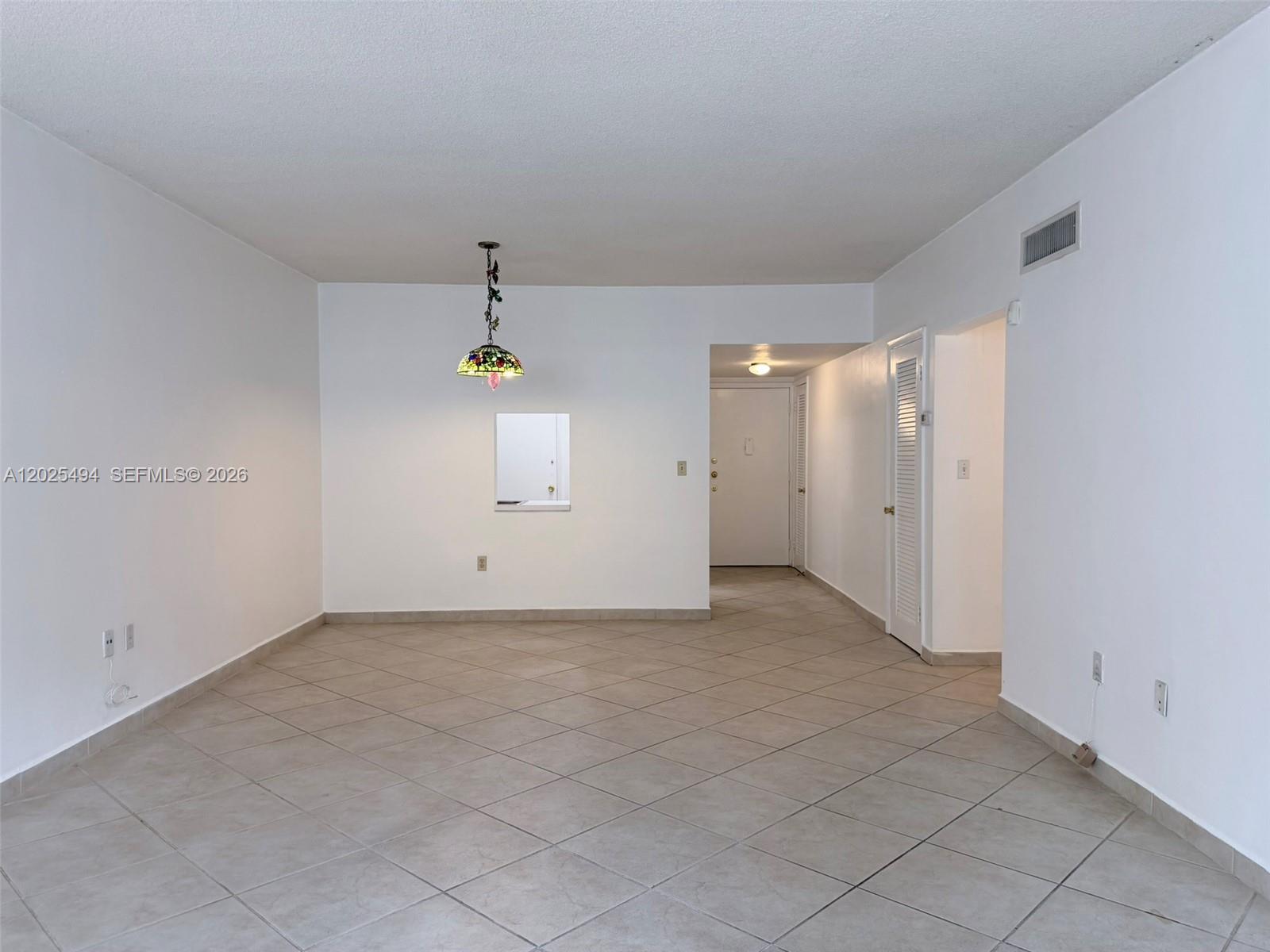 9159 Southwest 77th Avenue, Unit 112 Miami, FL 33156 - Photo 15 of 38 an empty room with closet and mirror