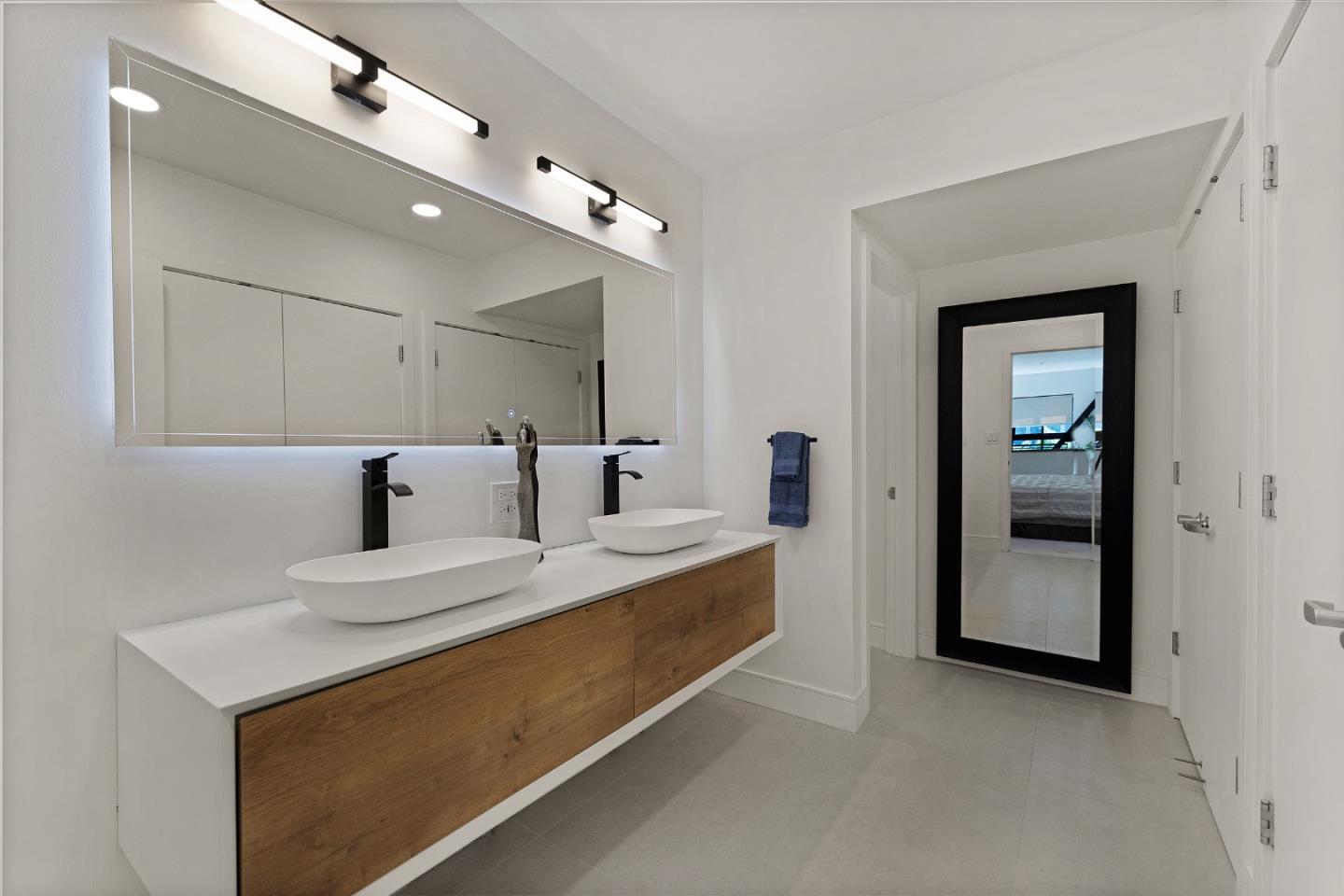 333 Santana Row, Unit 224 San Jose, CA 95128 - Photo 20 of 30 a large white room with a large mirror and vanity