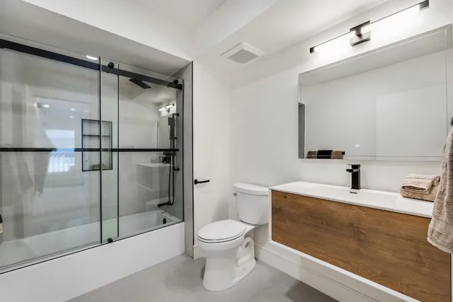 a bathroom with a toilet sink and shower