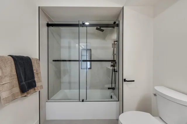 a bathroom with a shower and toilet
