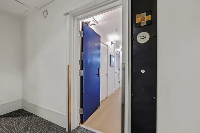 a view of a hallway with wooden floor