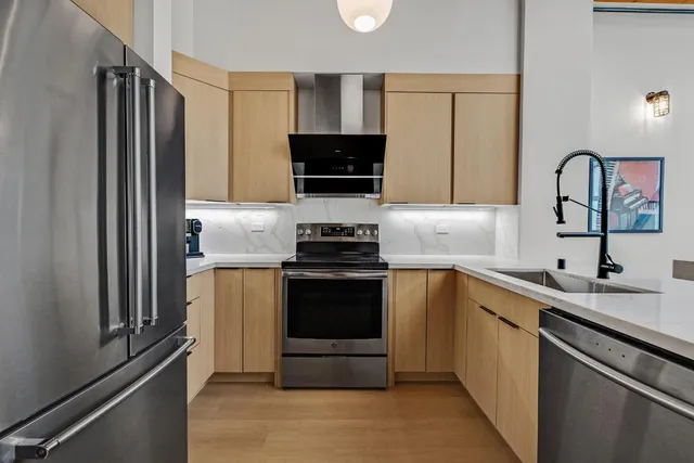 a kitchen with a sink and a stove top oven