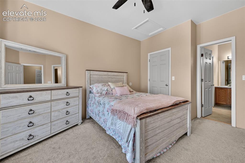 2141 Legacy Ridge View, Unit 109 Colorado Springs, CO 80910 - Photo 10 of 23 a bedroom with a bed and a dresser
