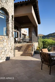 a view of an outdoor dining space with a table and chairs