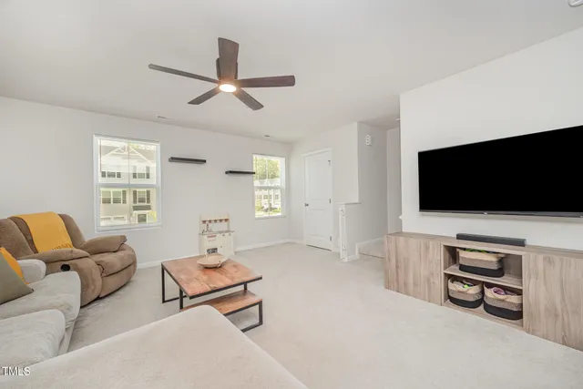 a living room with furniture and kitchen view