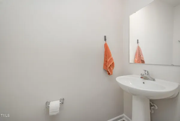 a kitchen with granite countertop a sink cabinets and wooden floor