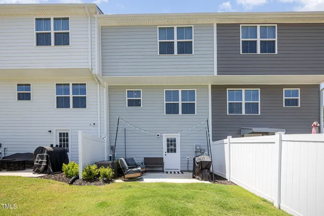 a view of a house with a yard and sitting area