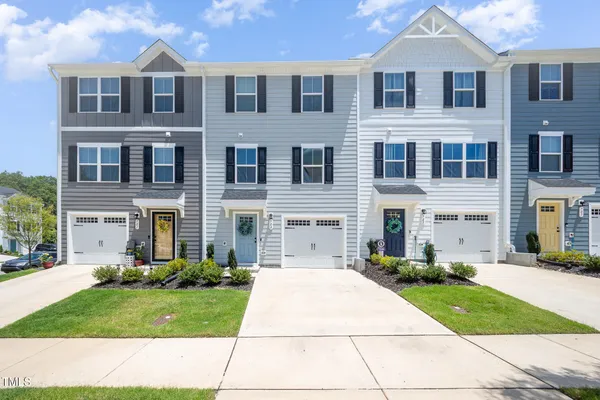 a picture of floor with a white wall and picture