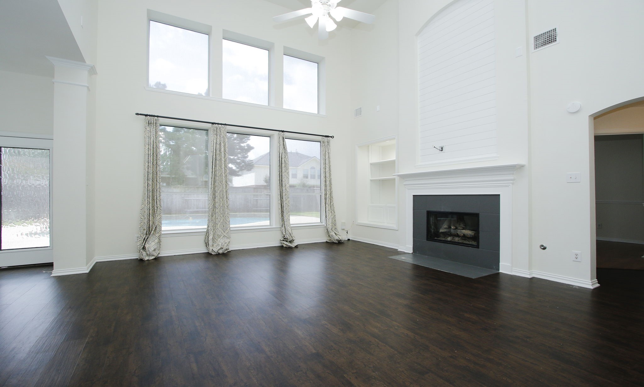 1210 Berwick Manor Court Spring, TX 77379 - Photo 17 of 50 a view of an empty room with wooden floor fireplace and a window