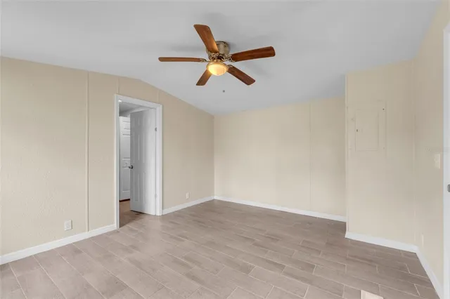 a view of empty room with ceiling fan