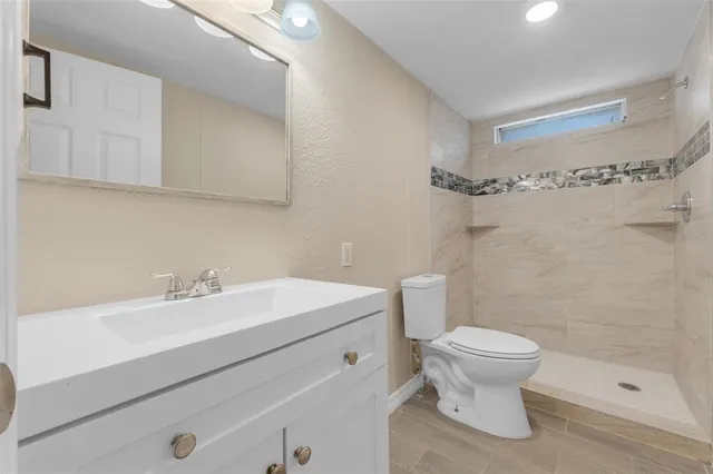 a bathroom with a sink toilet and shower