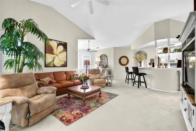 a dining room with furniture and a kitchen view