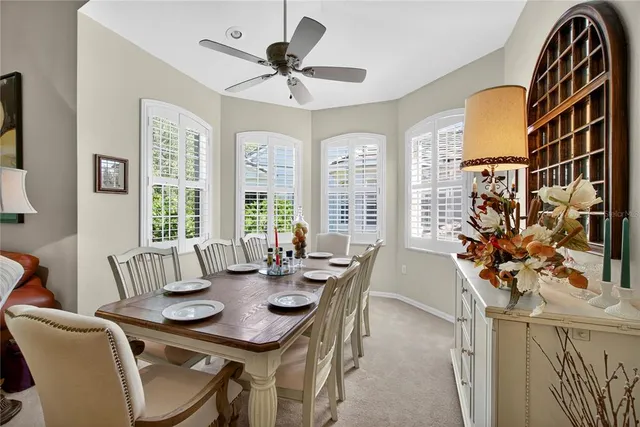 a dining room with furniture and potted plant