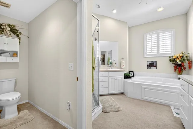 a front view of a multi story residential apartment building with yard and green space