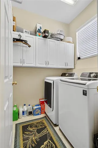 a view of a lake with a yard and a wooden fence