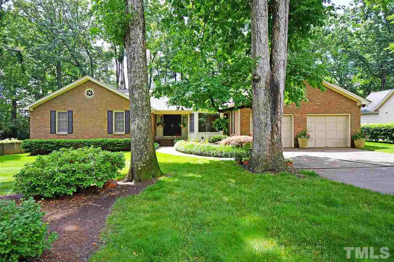 9437 Springdale Drive Raleigh, NC 27613 - Photo 1 of 30 a front view of a house with a yard and trees