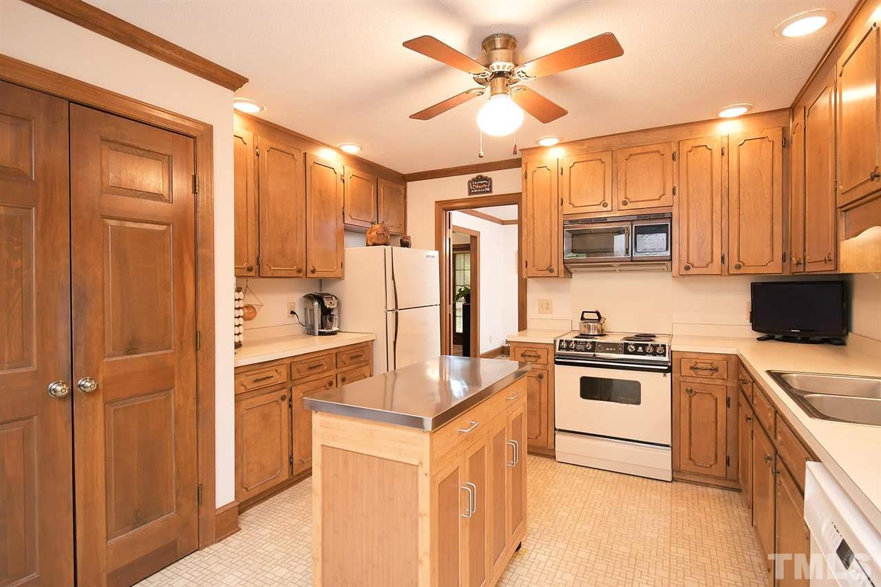 9437 Springdale Drive Raleigh, NC 27613 - Photo 21 of 30 a kitchen with cabinets stainless steel appliances and a window