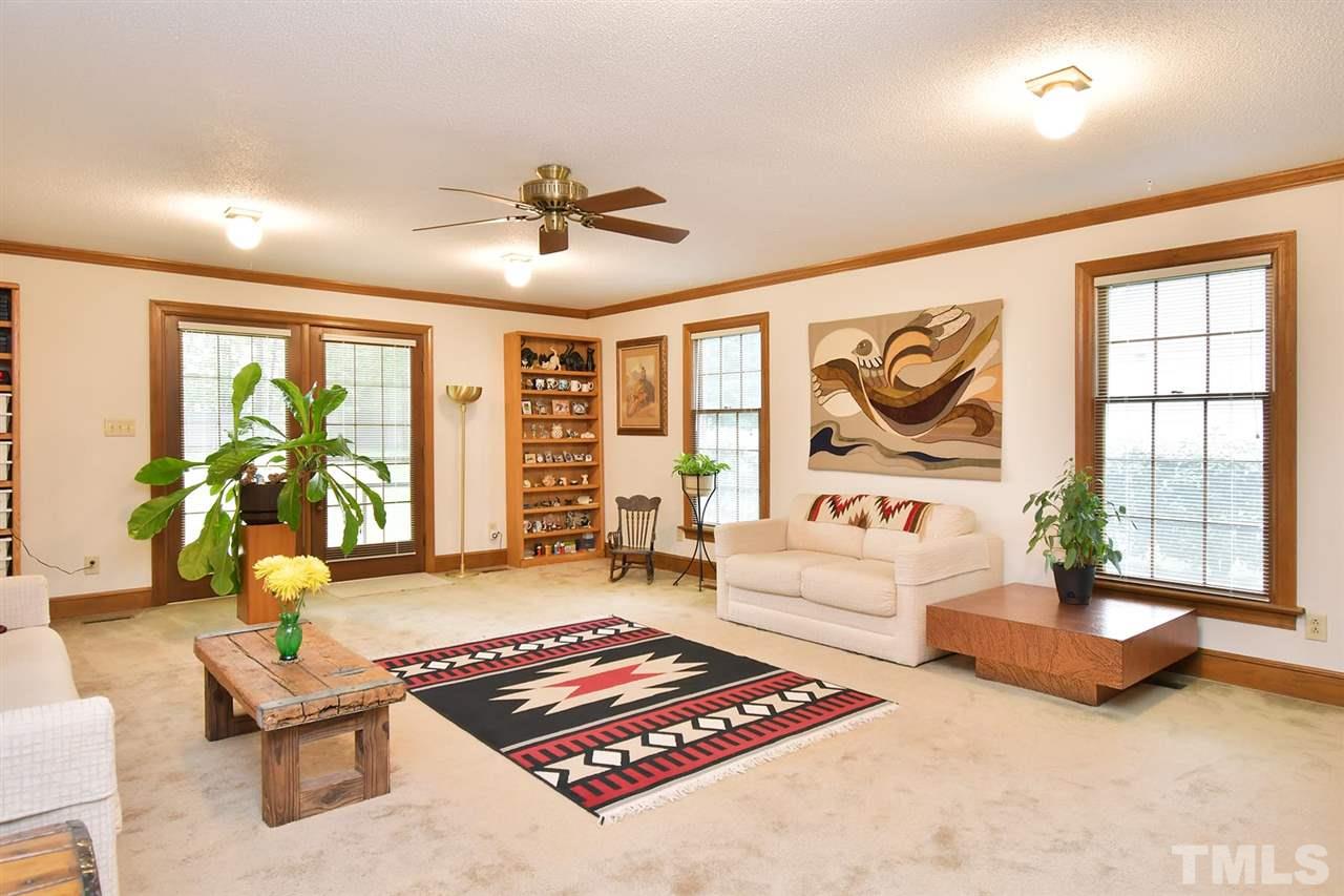 9437 Springdale Drive Raleigh, NC 27613 - Photo 24 of 30 a living room with furniture and a large window