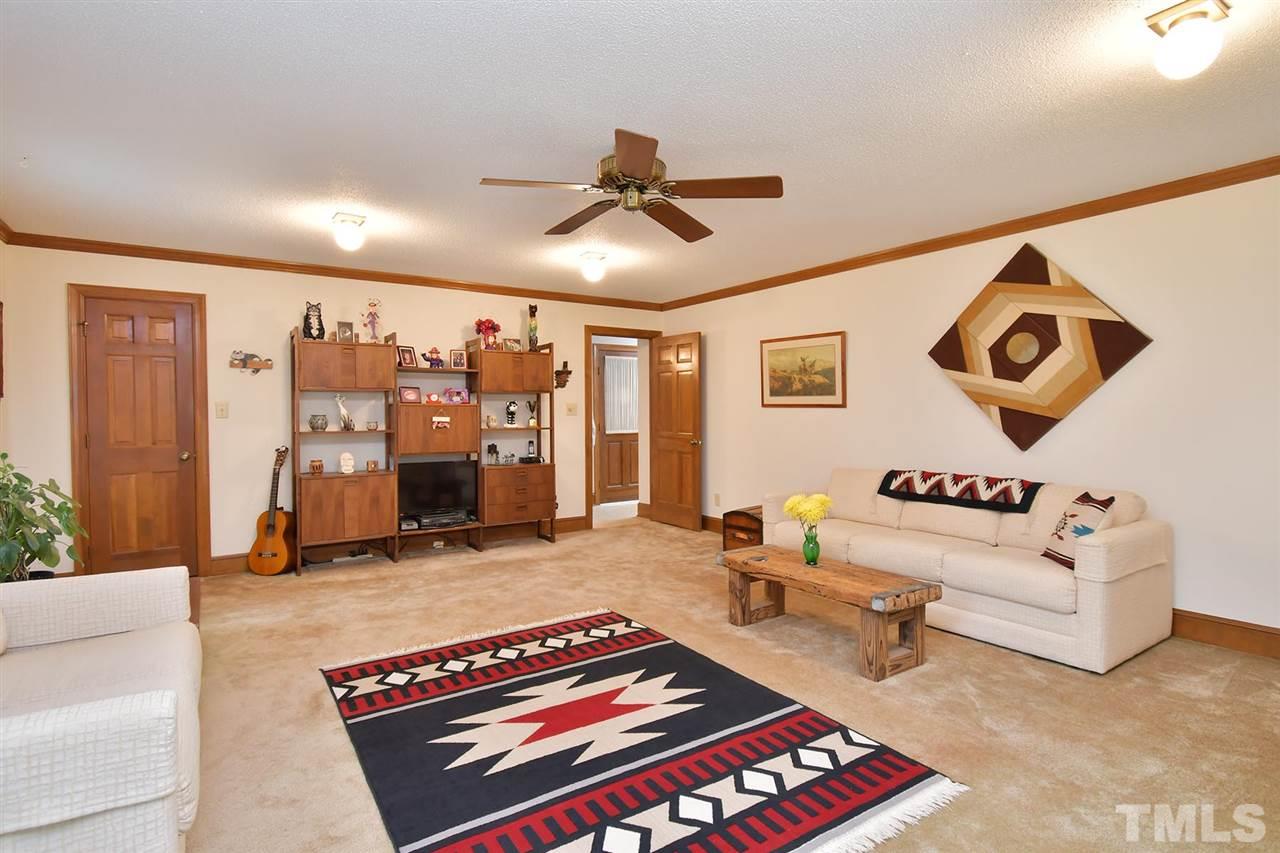 9437 Springdale Drive Raleigh, NC 27613 - Photo 25 of 30 a living room with furniture and flat screen tv