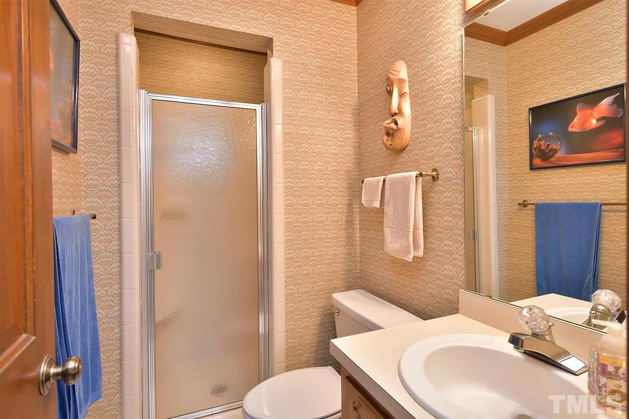 9437 Springdale Drive Raleigh, NC 27613 - Photo 26 of 30 a bathroom with a toilet sink shower and mirror
