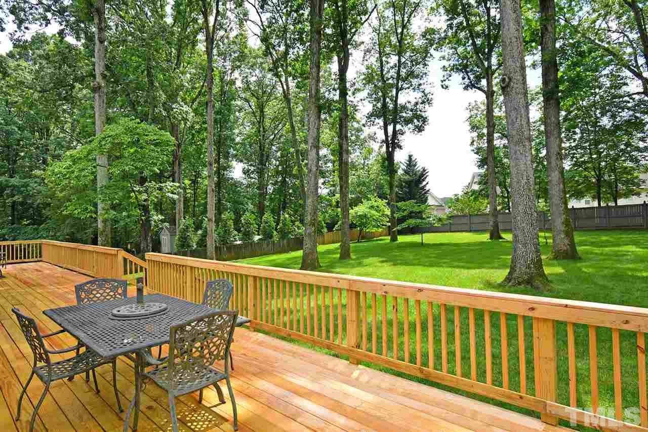 9437 Springdale Drive Raleigh, NC 27613 - Photo 27 of 30 a view of backyard with a table and chairs