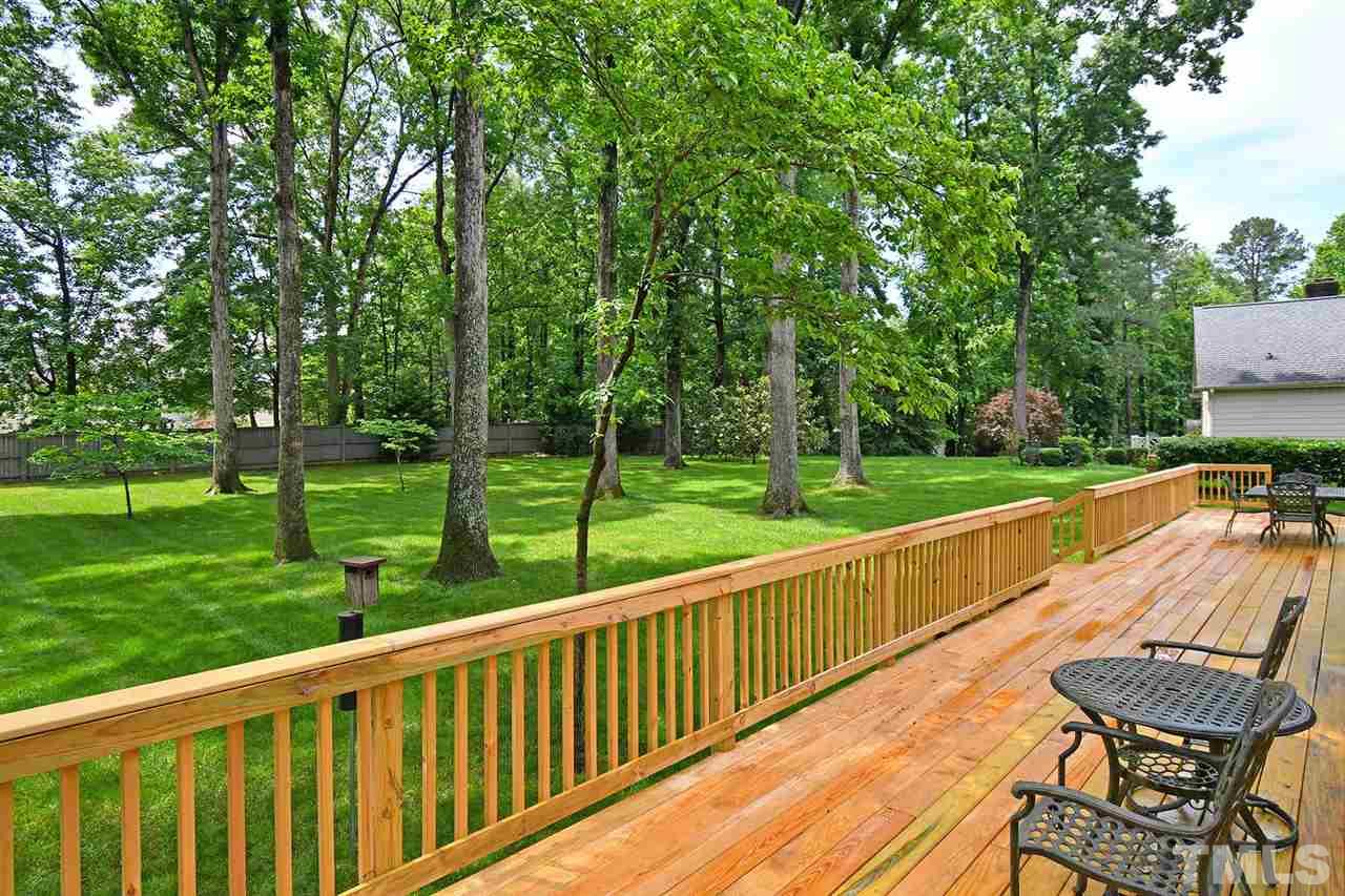 9437 Springdale Drive Raleigh, NC 27613 - Photo 28 of 30 a view of a wooden deck and a backyard