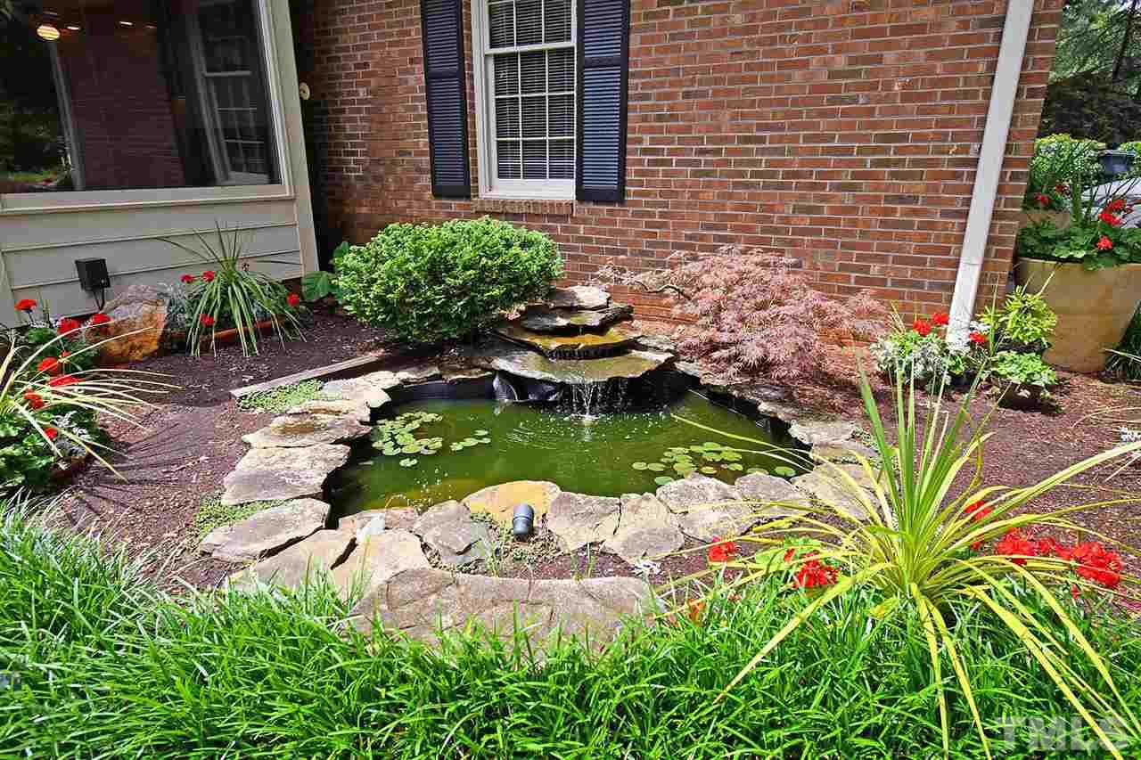 9437 Springdale Drive Raleigh, NC 27613 - Photo 6 of 30 a view of a backyard with plants