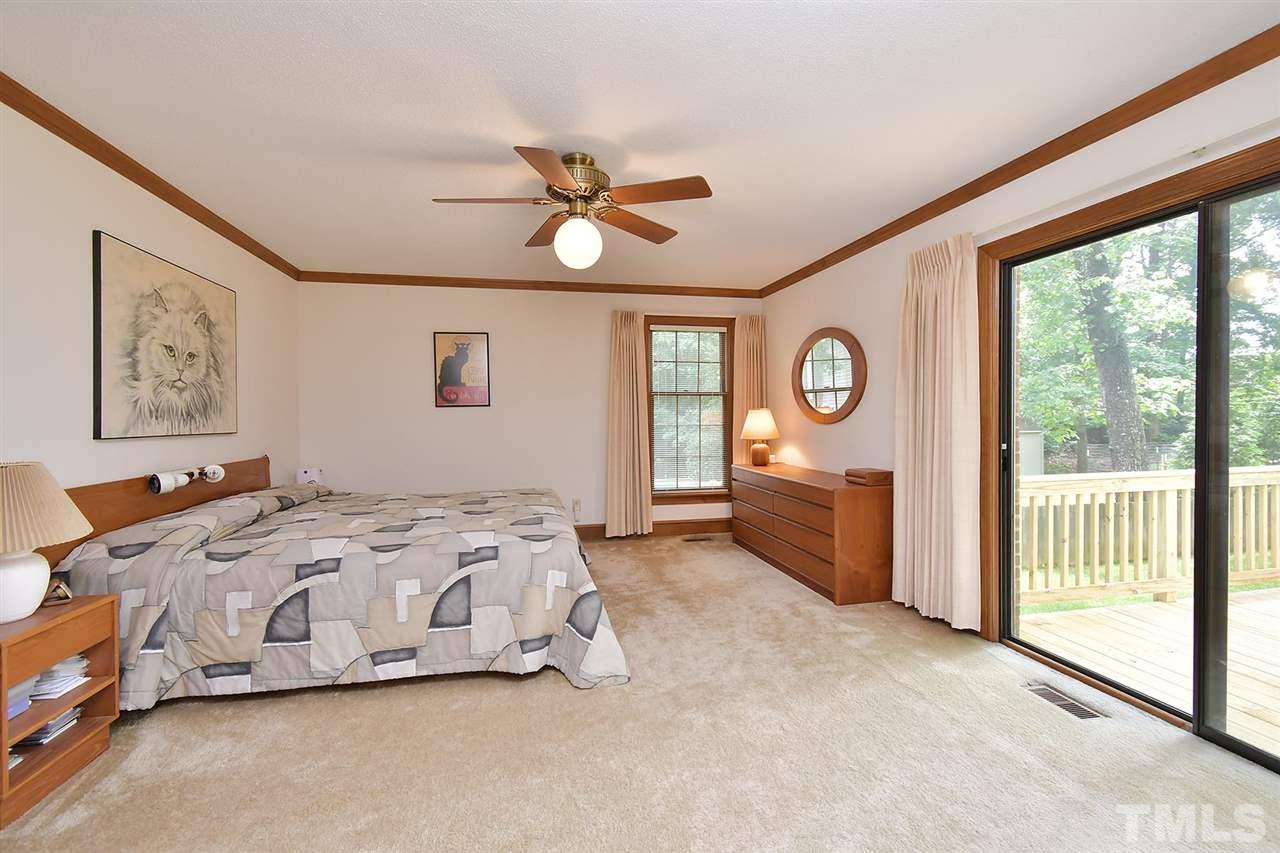 9437 Springdale Drive Raleigh, NC 27613 - Photo 10 of 30 a spacious bedroom with a bed and a large window