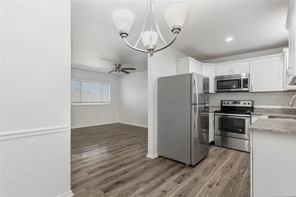 a kitchen with wooden cabinets and stainless steel appliances