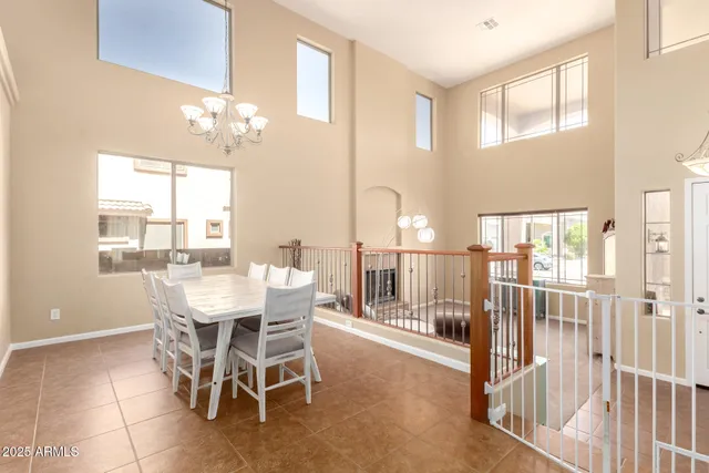 a kitchen with a chandelier a sink and cabinets